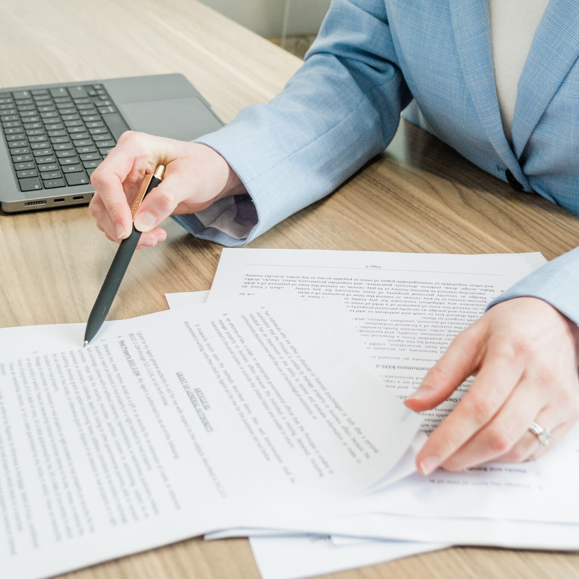 young couple signing lease agreement while having meeting with real estate